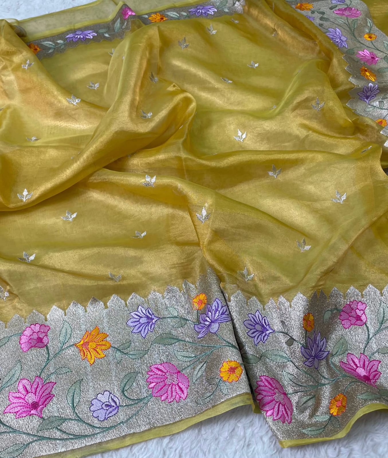 Banarasi Pure Tissue Saree adorned with intricate embroidery, enriched with luxurious silver zari weaving