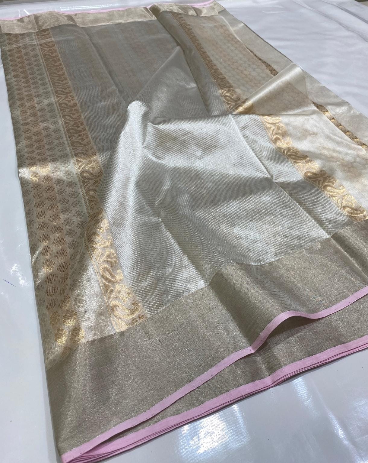 Ivory White Chanderi Handloom Pattu Tissue Silk Saree With Gold Zari Woven Motifs, Elegant Tissue Finish, Rich Woven Border And Matching Blouse Piece.