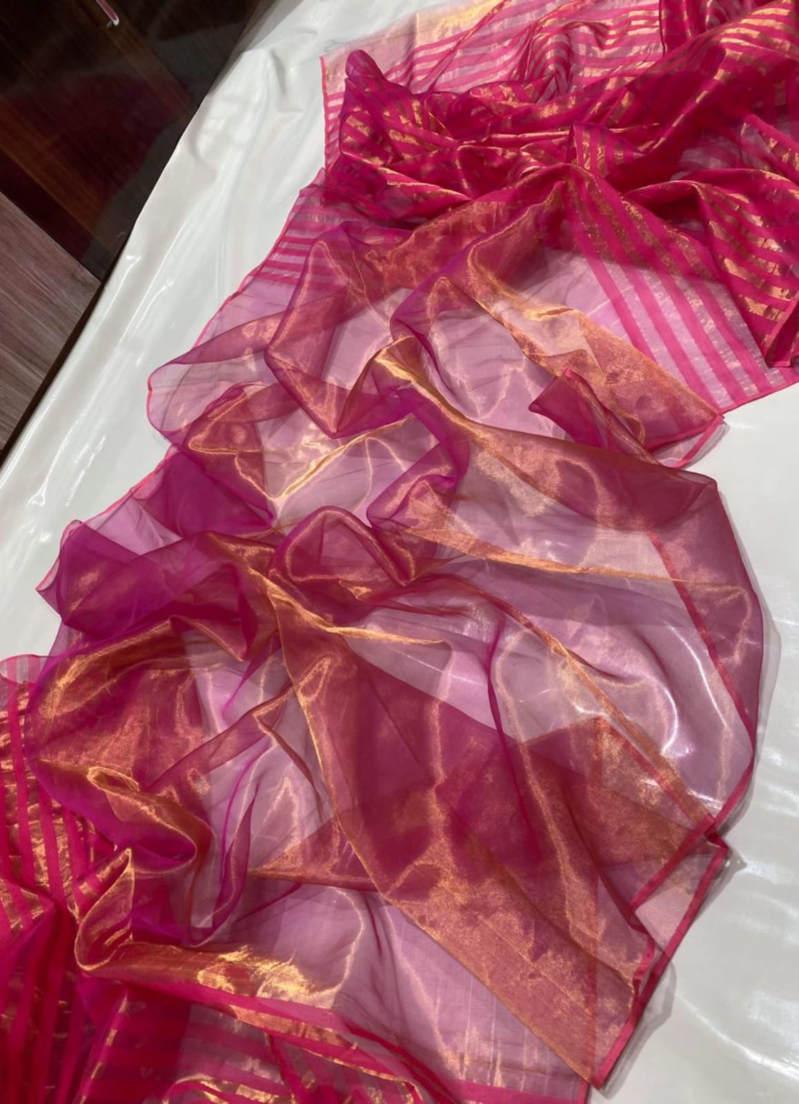 Rani Pink Chanderi Handloom Pattu Tissue Silk Saree With Golden Tissue Finish, Zari Woven Striped Pallu, Elegant Border And Matching Blouse Piece.