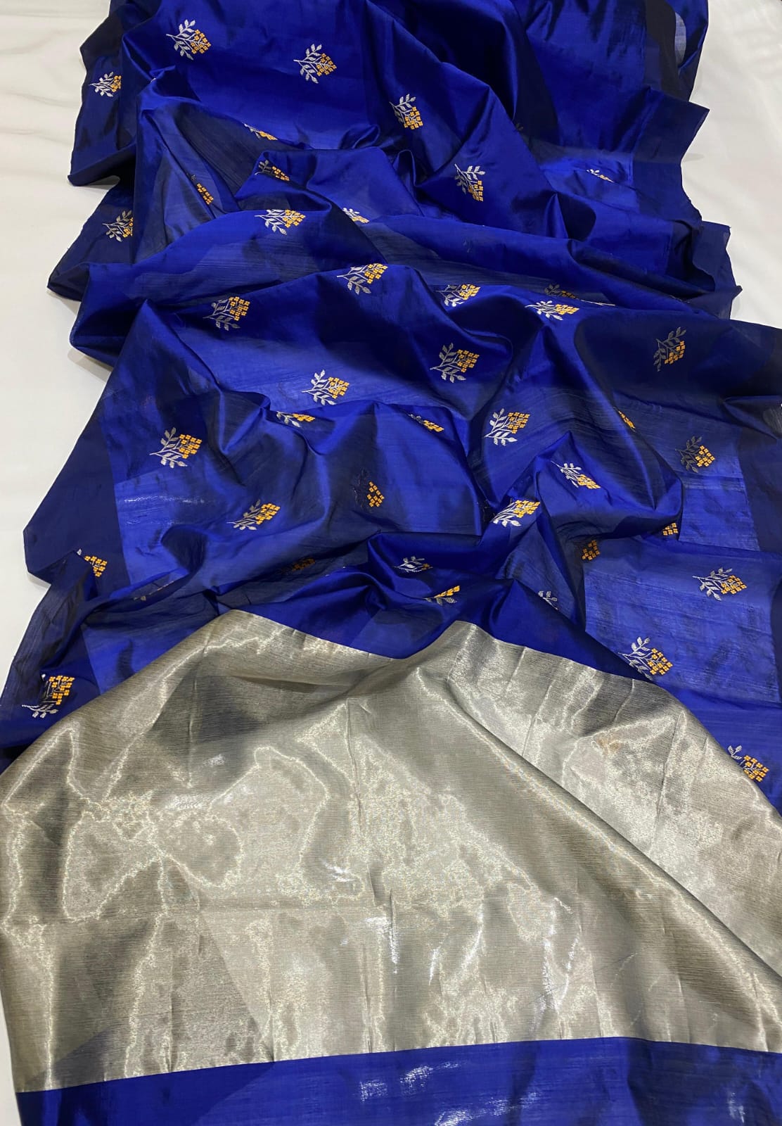 Royal Blue Chanderi Handloom Pattu Tissue Silk Saree With Silver And Golden Zari Floral Motifs, Rich Tissue Silk Pallu And Matching Blouse Piece.