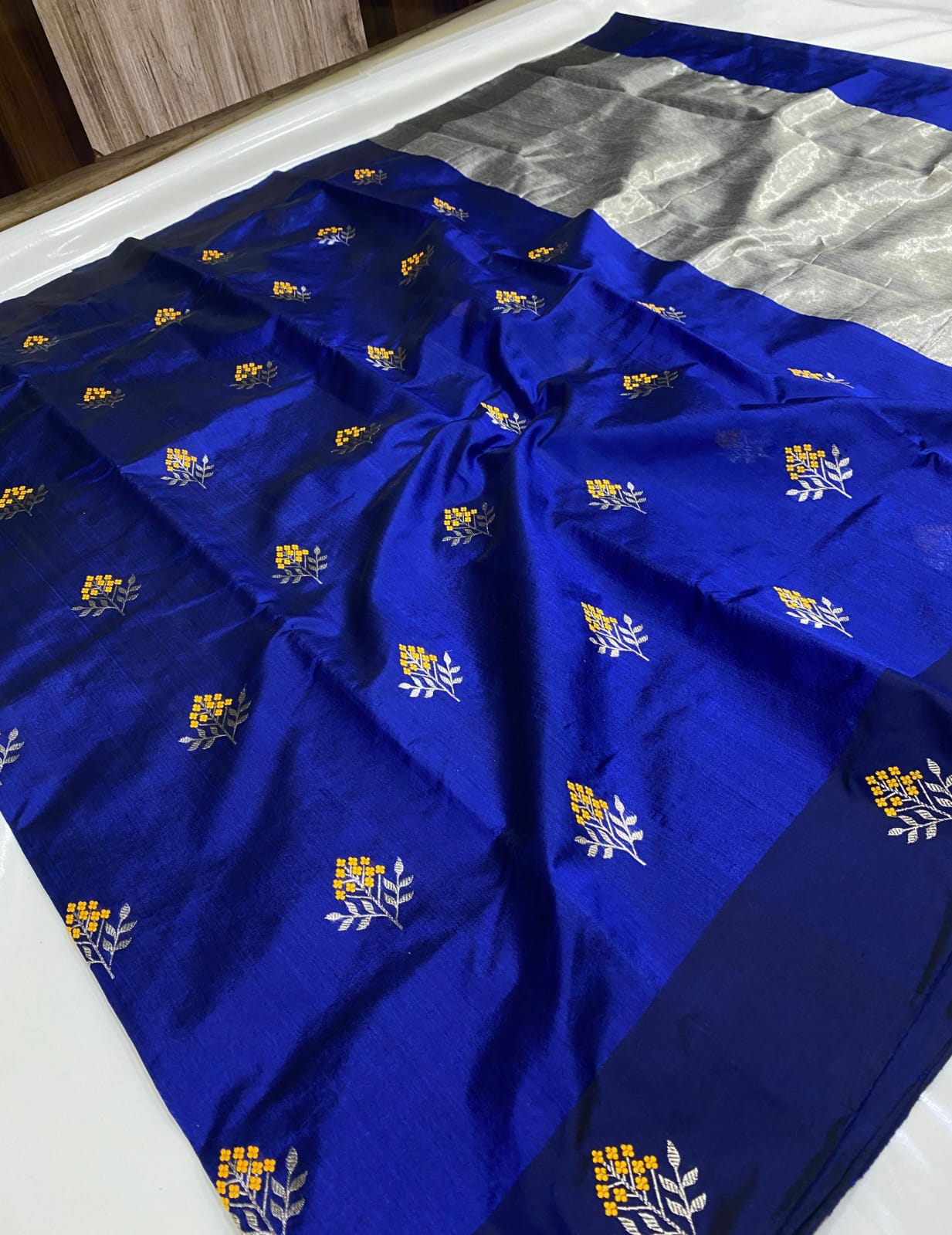Royal Blue Chanderi Handloom Pattu Tissue Silk Saree With Silver And Golden Zari Floral Motifs, Rich Tissue Silk Pallu And Matching Blouse Piece.