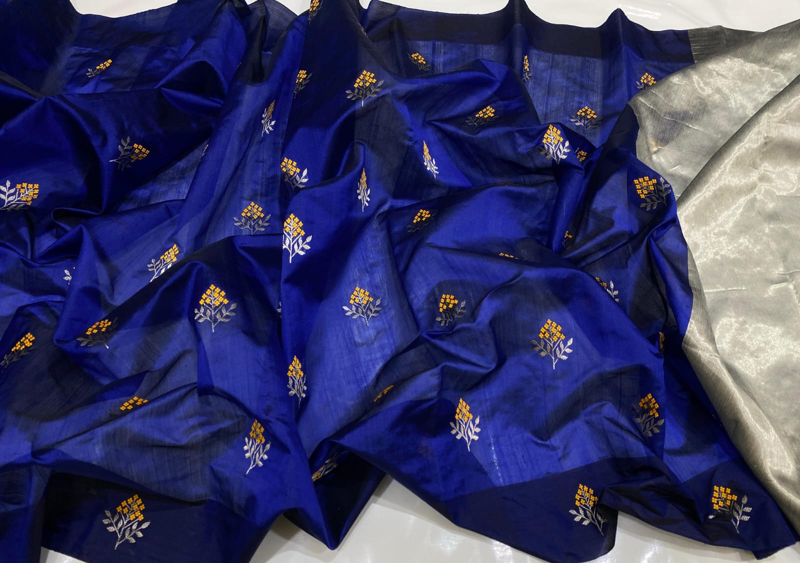 Royal Blue Chanderi Handloom Pattu Tissue Silk Saree With Silver And Golden Zari Floral Motifs, Rich Tissue Silk Pallu And Matching Blouse Piece.
