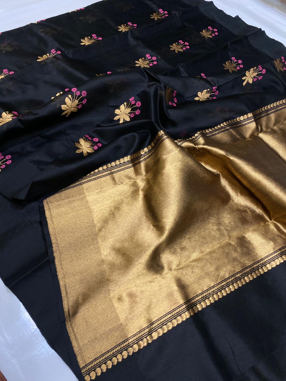 Black Chanderi Handloom Pattu Tissue Silk Saree Golden Border With Pink And Golden Zari Floral Motifs, Rich Tissue Silk Pallu And Matching Blouse Piece.