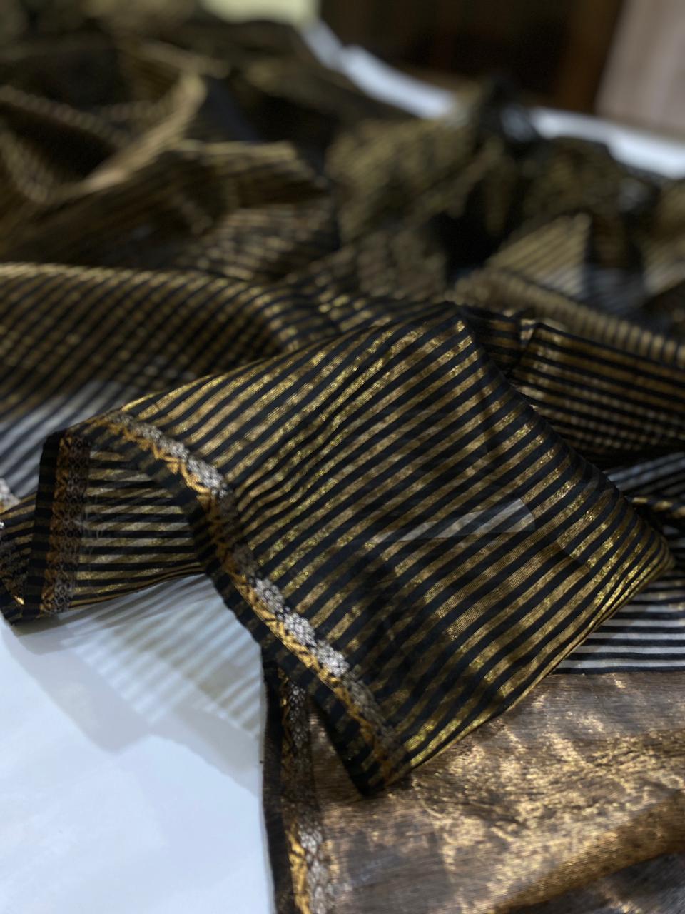Black Chanderi Handloom Pattu Silk Saree With Blouse Featuring Elegant Golden Striped Weave Design And Traditional Festive Look.