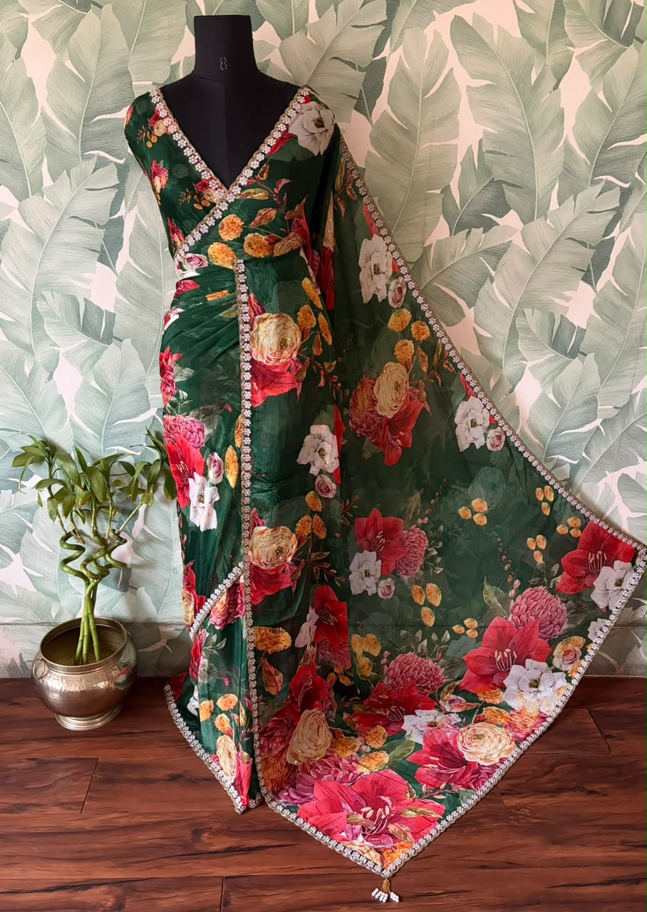 Premium Pure Chinnon Crepe Silk Saree in emerald green with elegant floral digital print, embellished with intricate zardozi, pearl, and cut daana handwork border, paired with a matching Pure Chinnon handwork blouse piece for weddings, festive occasions, and party wear.