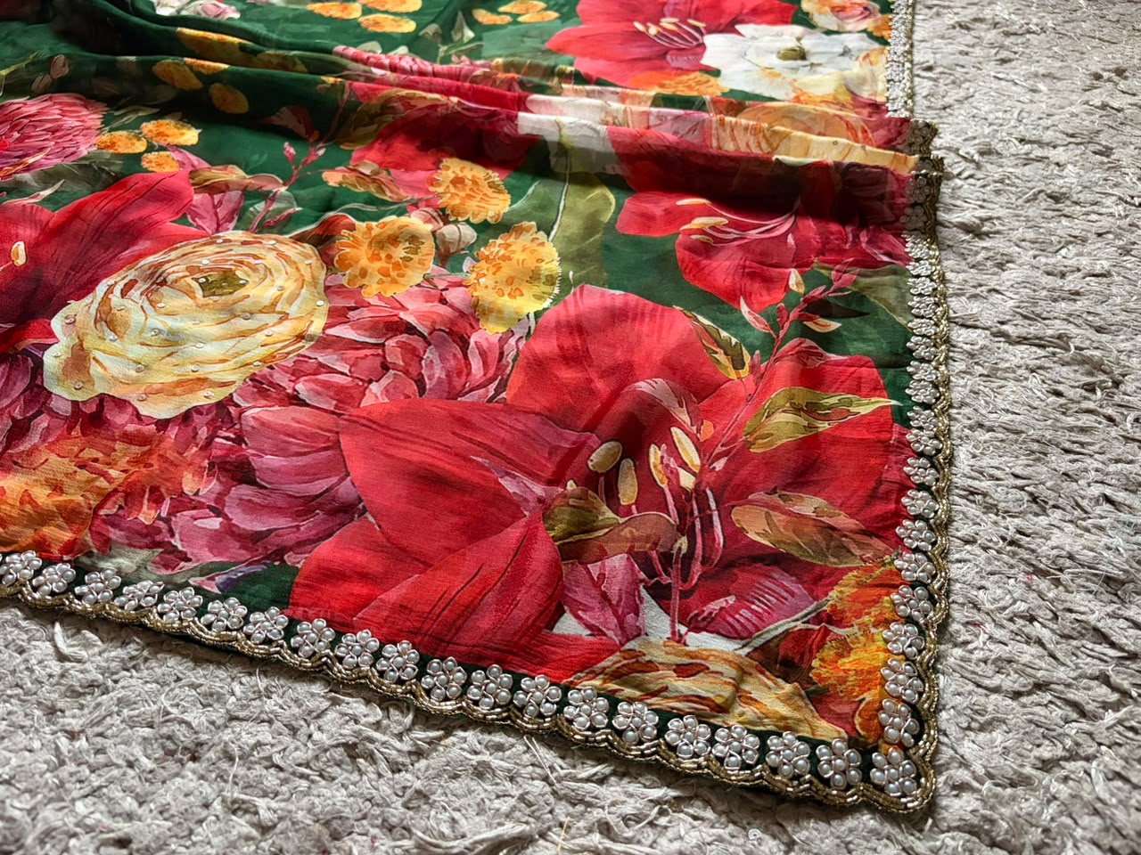 Premium Pure Chinnon Crepe Silk Saree in emerald green with elegant floral digital print, embellished with intricate zardozi, pearl, and cut daana handwork border, paired with a matching Pure Chinnon handwork blouse piece for weddings, festive occasions, and party wear.
