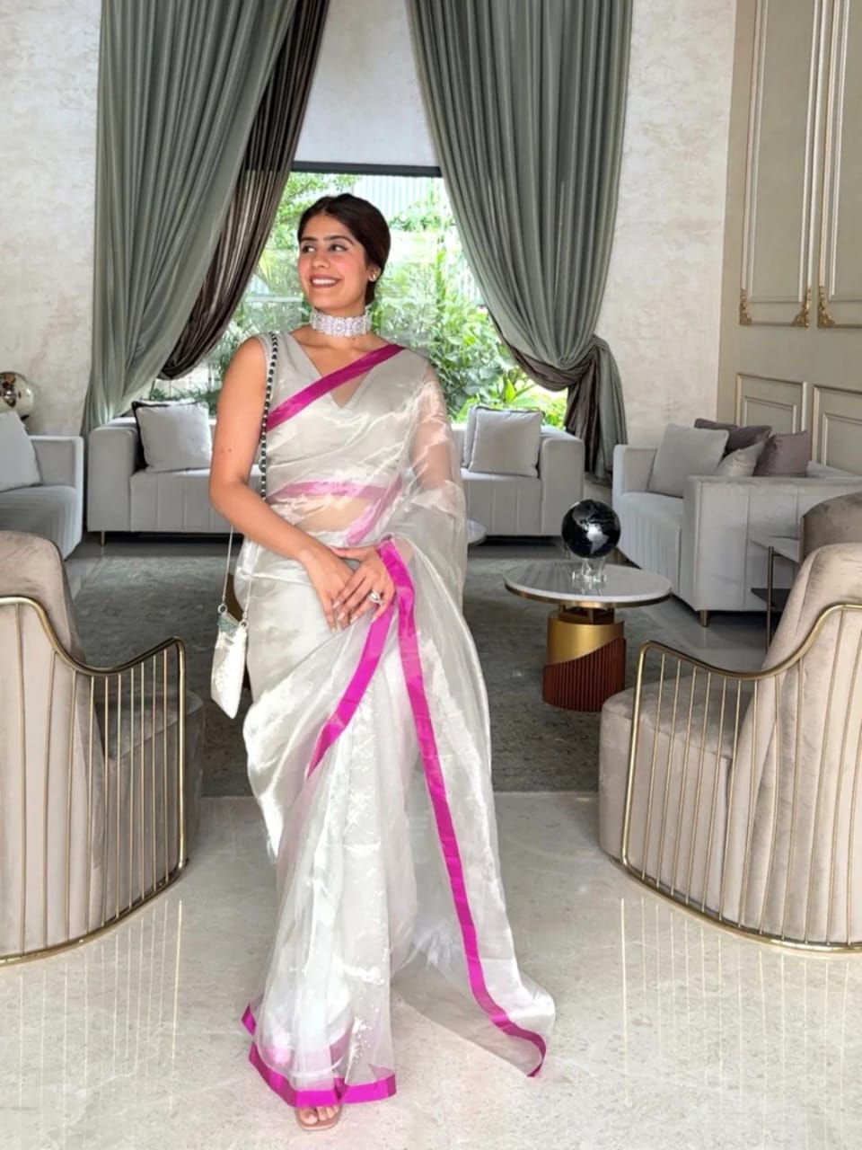 Premium Zari Weaving Tissue Silk Saree featuring a lustrous silver-gold body, elegant small zari border, striped pink woven pallu, and matching running blouse piece, ideal for weddings, festive occasions, and traditional wear.