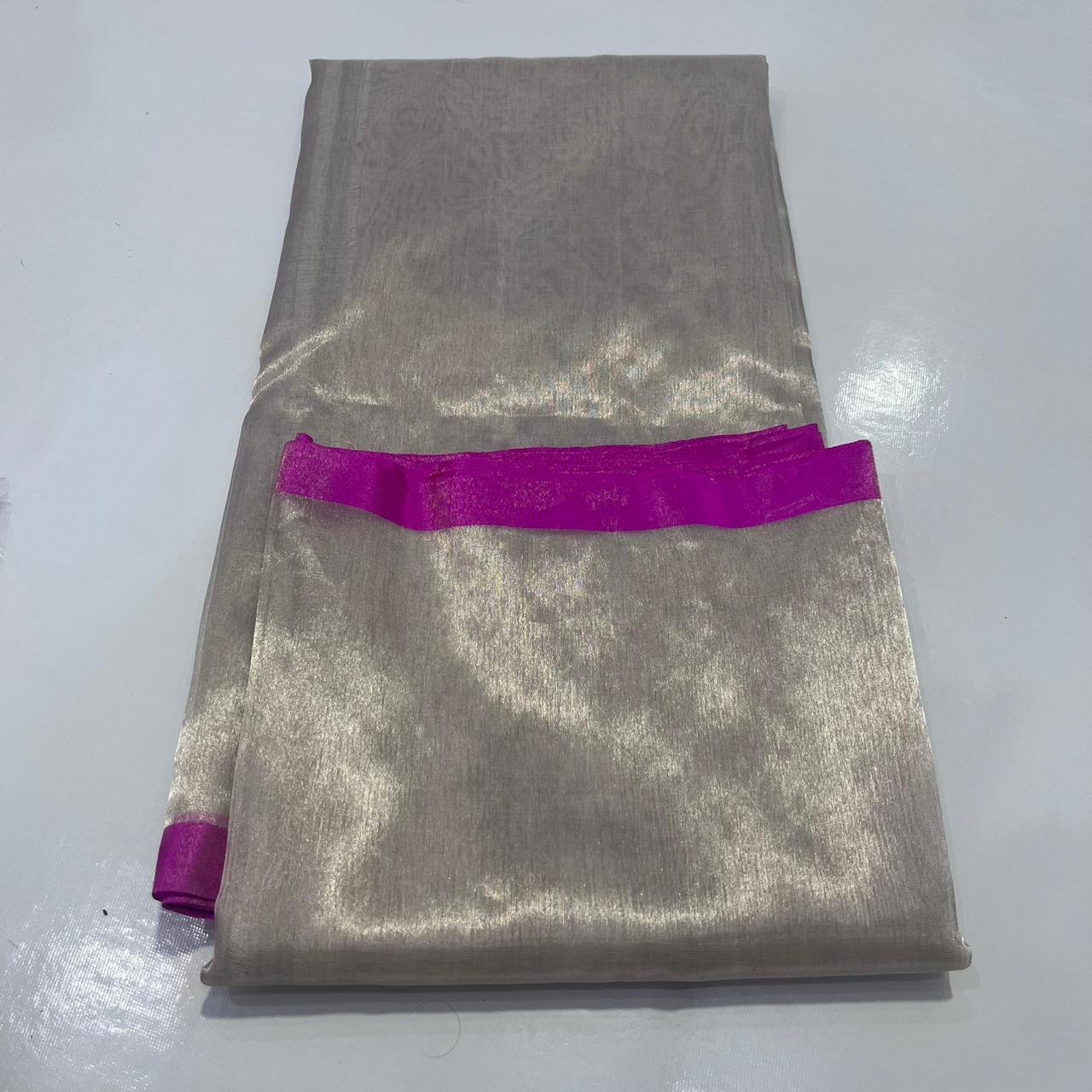 Premium Zari Weaving Tissue Silk Saree featuring a lustrous silver-gold body, elegant small zari border, striped pink woven pallu, and matching running blouse piece, ideal for weddings, festive occasions, and traditional wear.
