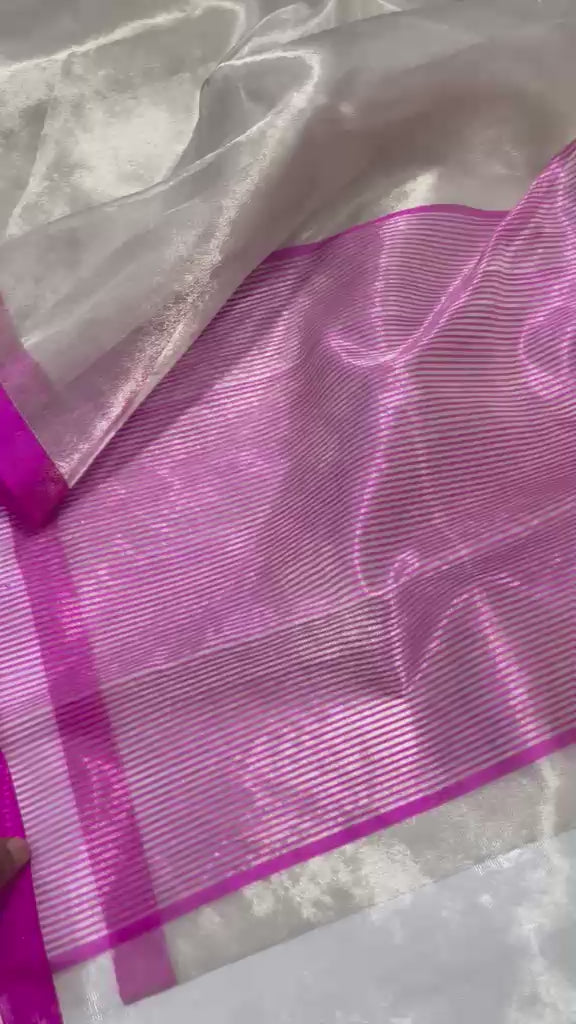 Premium Zari Weaving Tissue Silk Saree featuring a lustrous silver-gold body, elegant small zari border, striped pink woven pallu, and matching running blouse piece, ideal for weddings, festive occasions, and traditional wear.